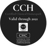 A black and white photo of the cch seal.