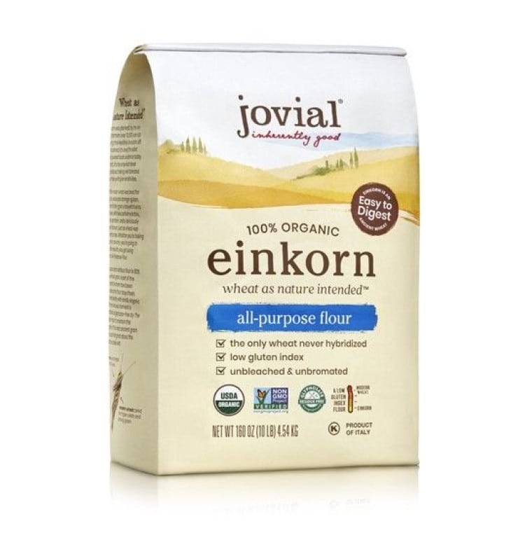 A bag of einkorn flour is sitting on the floor.